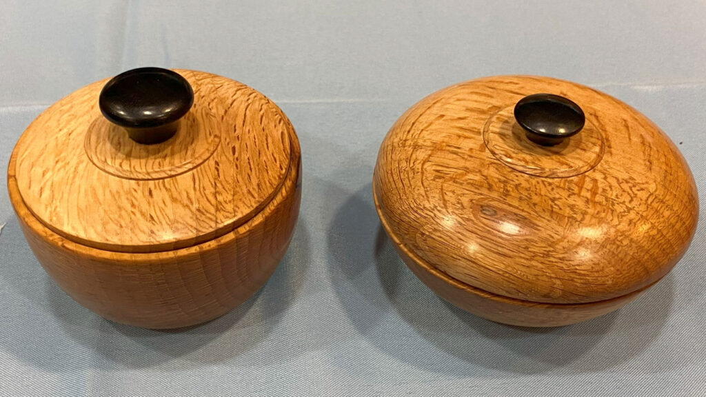 Jon Bishop: two oak lidded bowls with black handles.