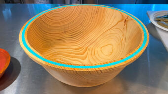 Blue spruce bowl with stone inlay along the rim by Robert Bley