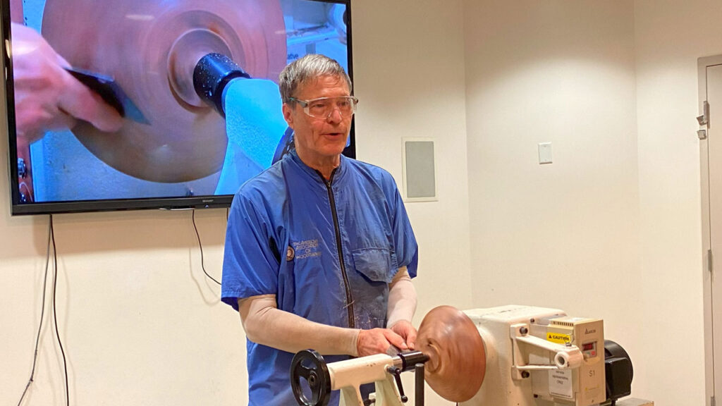 David Vannier demonstrates a scraper on a black walnut bowl.