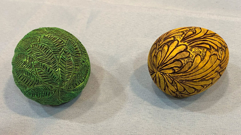 Turned eggs embellished with woodburning and paint.