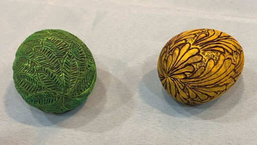 Turned eggs embellished with woodburning and paint.