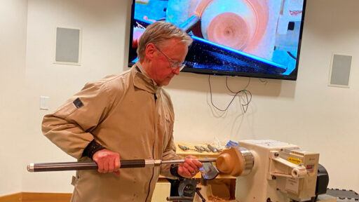 Tom Gaston demonstrates turning a wing bowl on a lathe