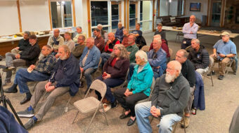 WBW members are watching Tom Gaston turning a bowl with handles