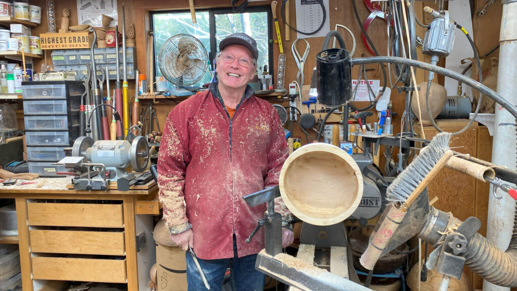 Dennis Lillis, in his woodturning workshop, demonstrated bowl turning and sanding.