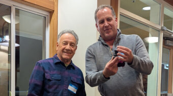 Jon Sauer presented a spinning top to Dan Boehmke. The top featured a betel nut and a blackwood holder, all embellished on a rose engine lathe.