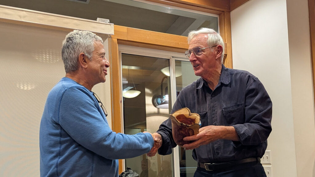 Bob Bley gave a live edge juniper vase to Tom Kenyon.