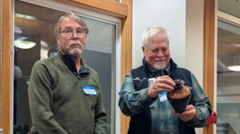 Gordon Peterson presented a red heart vase to Jim Koren.