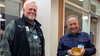 Jim Koren gave a madrone bowl with gold paint to Jon Sauer.