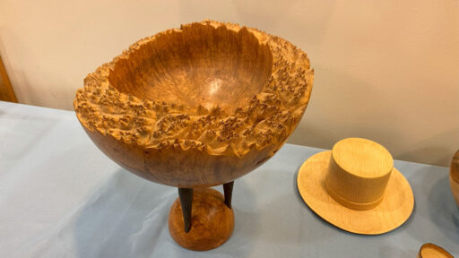 A maple burl bowl with a stand by Bob Bley and a mini cowboy hat by Jim Koren