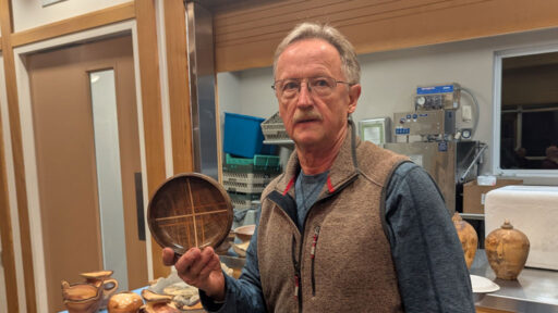 Tom Gaston turned a walnut bowl with mahogany and maple inlaid stripes