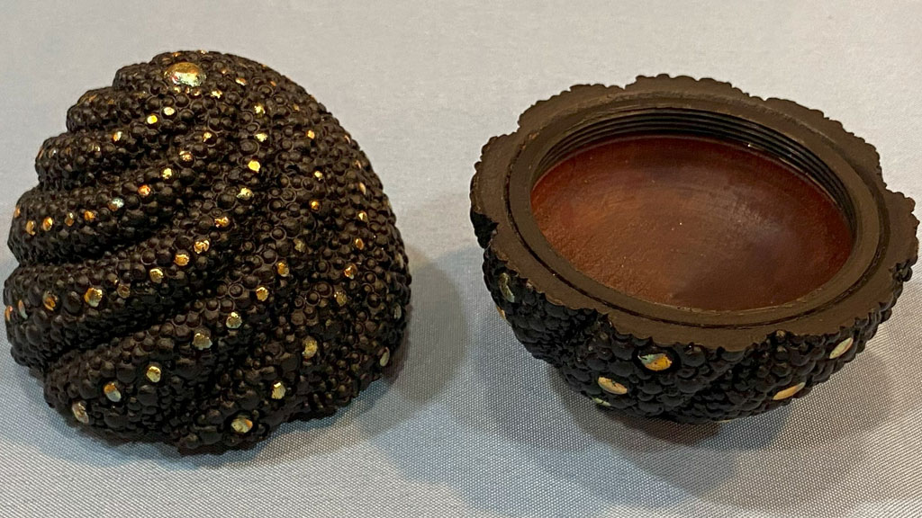 An egg-shaped box carved and embellished with rotary bits by Brad Bond.