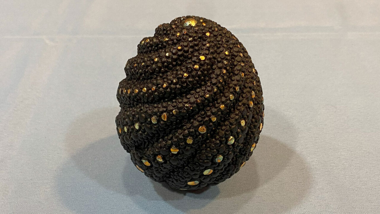 An egg-shaped box carved and embellished with rotary bits by Brad Bond.