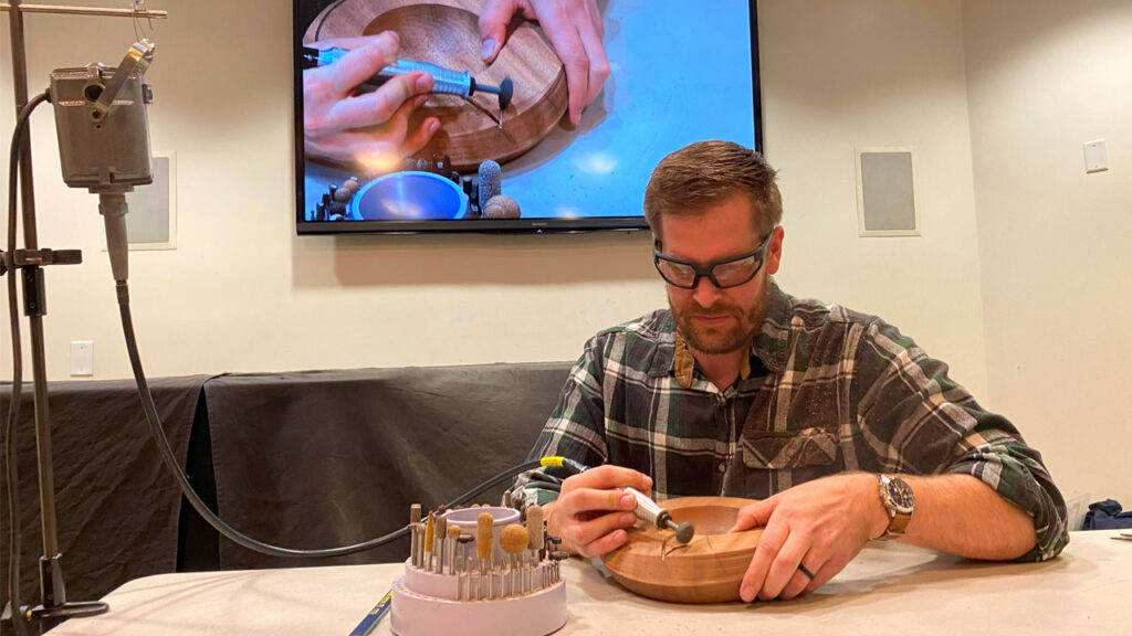 Brad Bond is decorating the surface of a turned bowl with rotary bits. See more on Instagram @qbranchwoodworks
