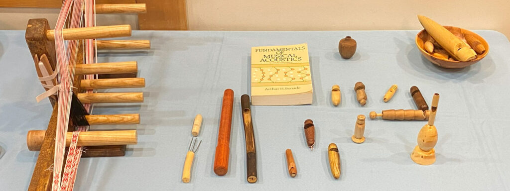 Table with woodturned projects turned with a skew: various whistles and an Inkle loom.