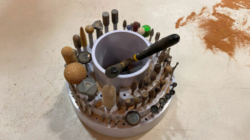 A stand with dozens of rotary burrs and power carving bits.