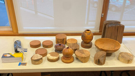 A table with a dozen woodturning blanks.