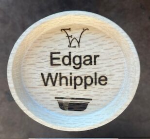 Name tag that is turned from oak and woodburned.