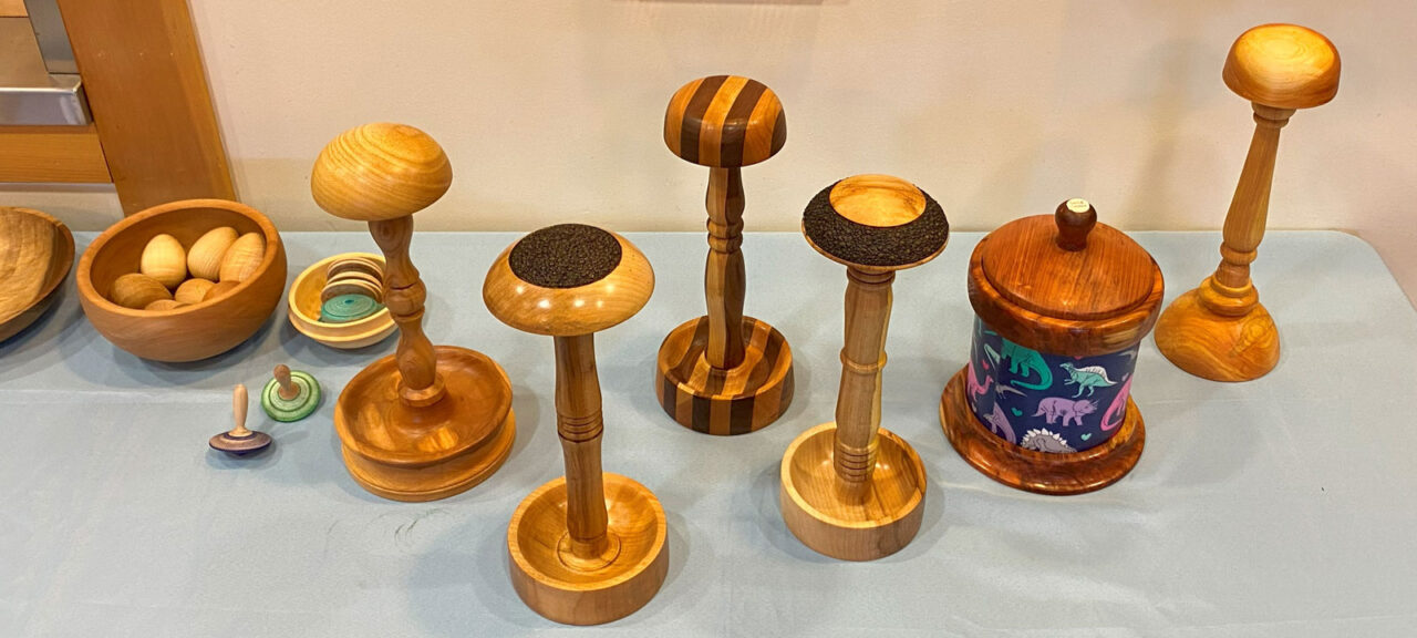 Turned wig-stands, a couple of spinning tops, and a beads-of-courage vessel.