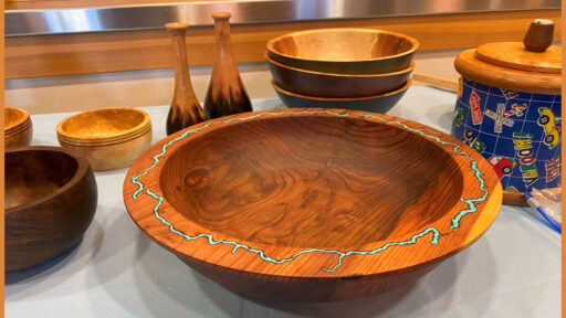 A woodturned bowl with a turquoise inlay in its rim
