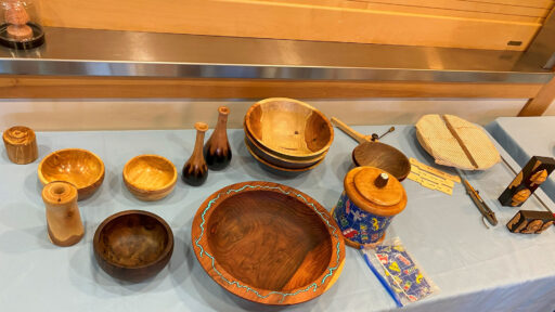 A table with a couple of dozens of woodturning projects.