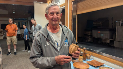 Dale shows a turned box that he made from olive wood.