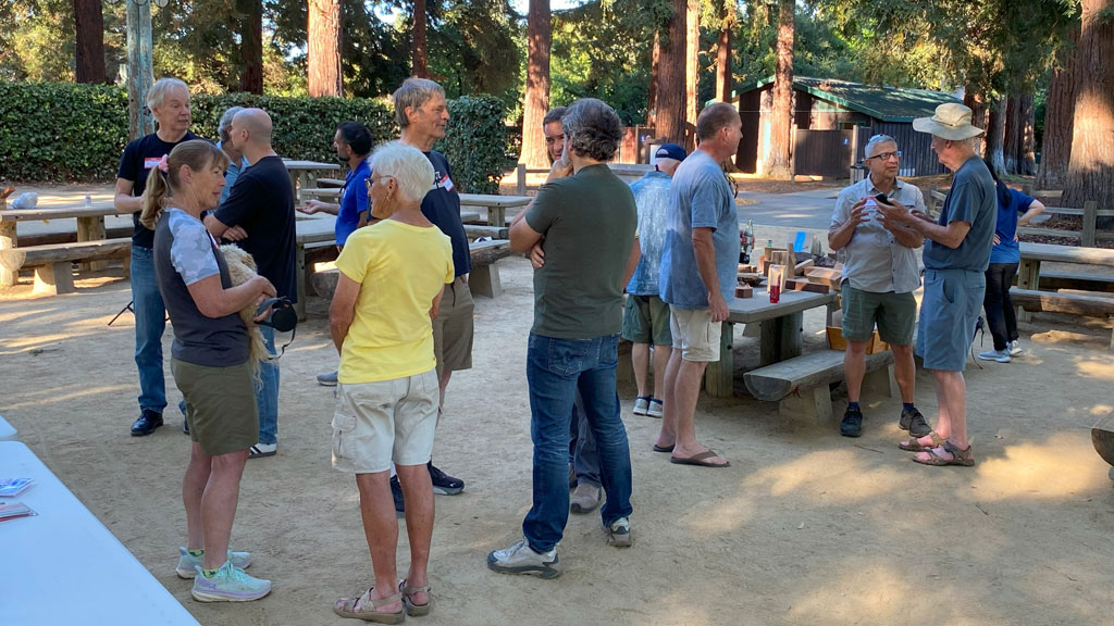 A group of people socializing during a woodturning picnic.