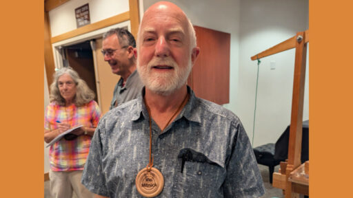 Vic turned his name badge from olive wood.