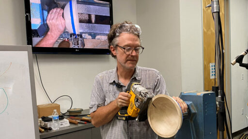 Mark Gardner makes a step in the rim of a bowl with a saw.