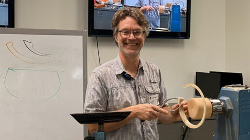 Mark Gardner measures the thickness of a bowl.