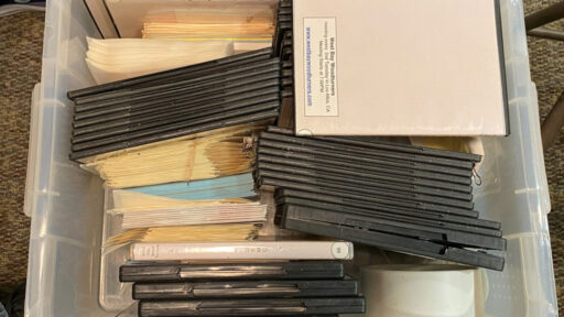 A box with dozens of woodturning DVDs.