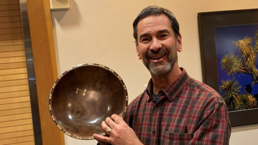 Chip is showing a walnut bowl decorated with bowties.