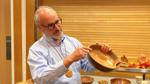 Daniel is showing a segmented bowl that he turned from various wood species.