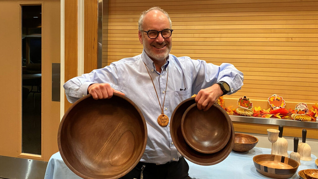 Daniel is showing three large bowls he turned from walnut.