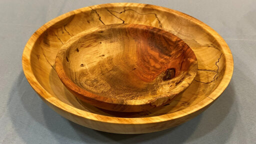 Two bowls turned on a lathe.