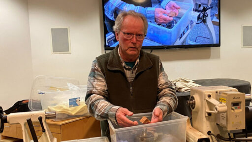 Dennis explained ways to turn a birdhouse ornament. He explained how to hold the birdhouse blank on the lathe.