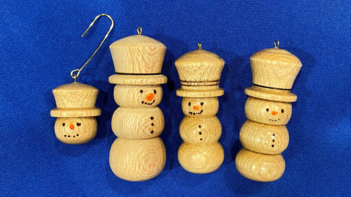 Four turned snowmen ornaments.