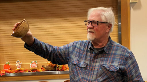 Jim Koren is showing a bowl he turned from plum wood.