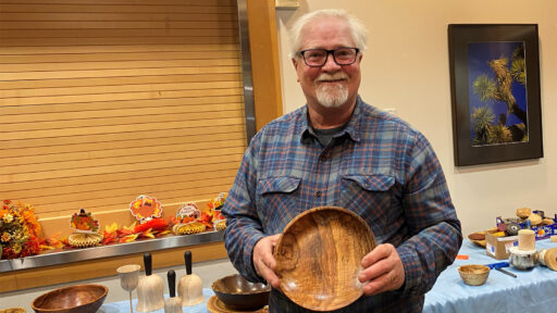 Jim Koren is showing a bowl he turned from plum wood.