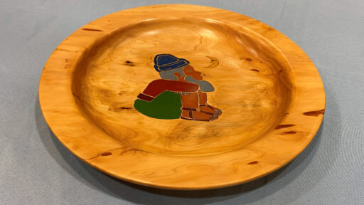 A woodturned plate with stone inlay.