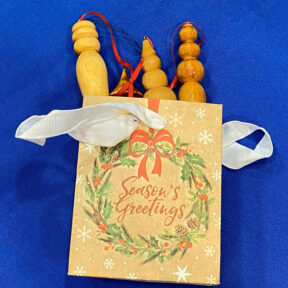 Turned icicles packaged in a colorful paper bag.