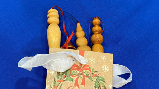 Turned icicles packaged in a colorful paper bag.