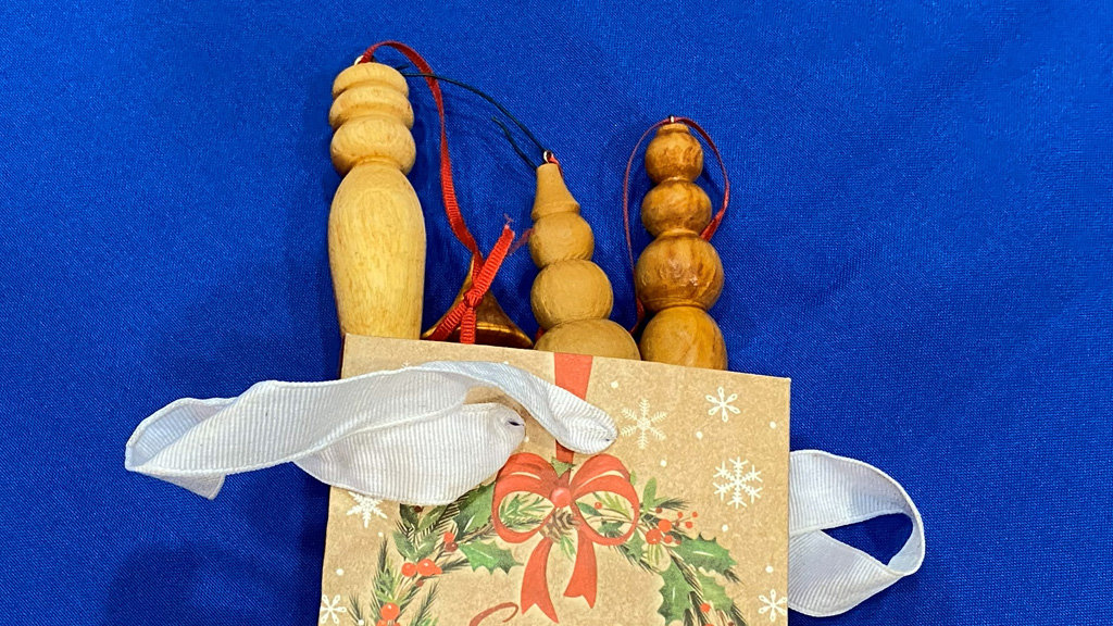 Turned icicles packaged in a colorful paper bag.