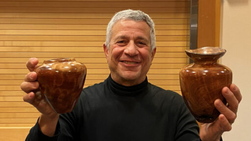 Bob shows two hollow forms he turned on a lathe.