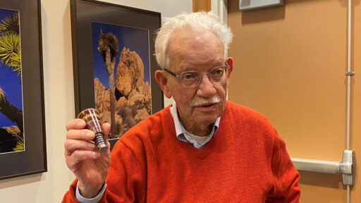 Bud shows a wooden bottle stopper that he turned on a lathe. He used wood of different species to make this item colorful. It is a great example of simple segmented turning.