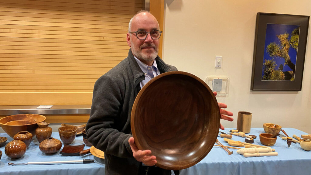 Daniel shows a large walnut bowl that he turned on a lathe