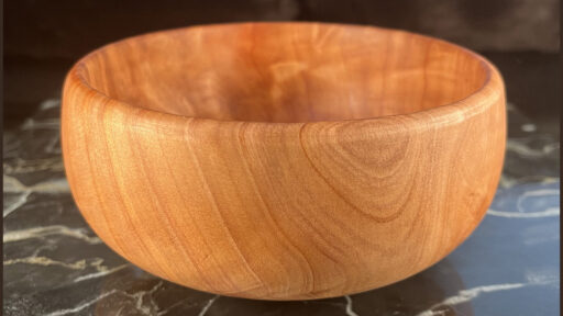 A small calabash bowl turned by Edgar from a light-colored wood with beautiful flaming grain. About 6" in diameter.