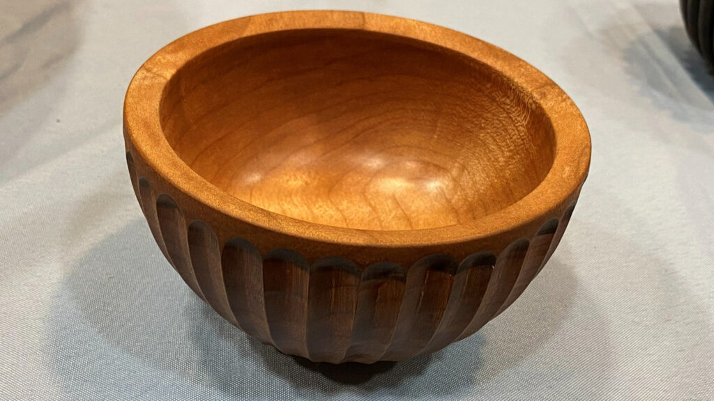 A small bowl turned by Jon on a lathe, with the outside surface decorated using a router.
