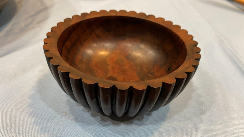 A small bowl turned by Jon on a lathe, with the outside surface decorated using a router.