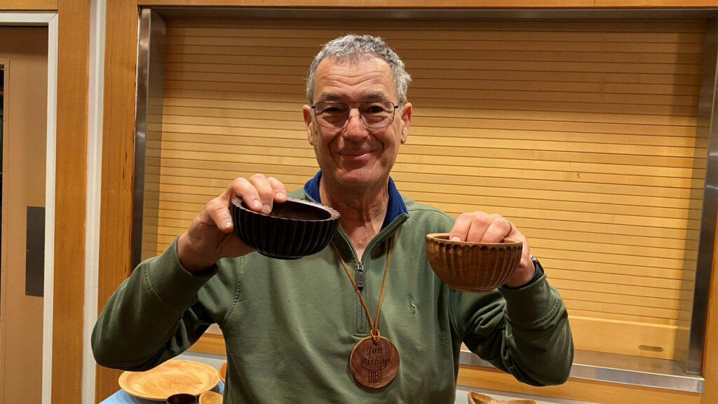 Jon shows two small bowls that he turned on a lathe and decorated using a router.