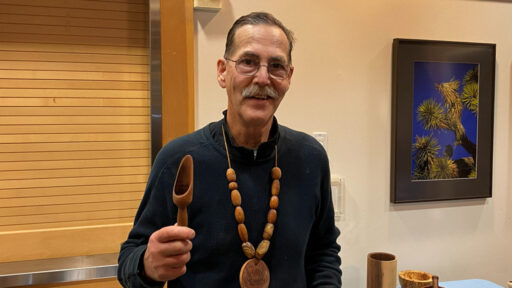 Kelly shows a wooden scoop that he turned on a lathe from broadleaf Maple